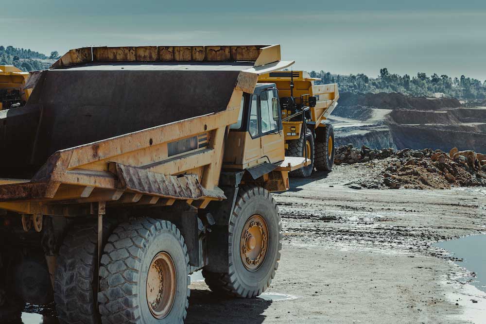 Two Mining Trucks Showing How Exhaust Systems Work and How It Affects Mining Truck Performance