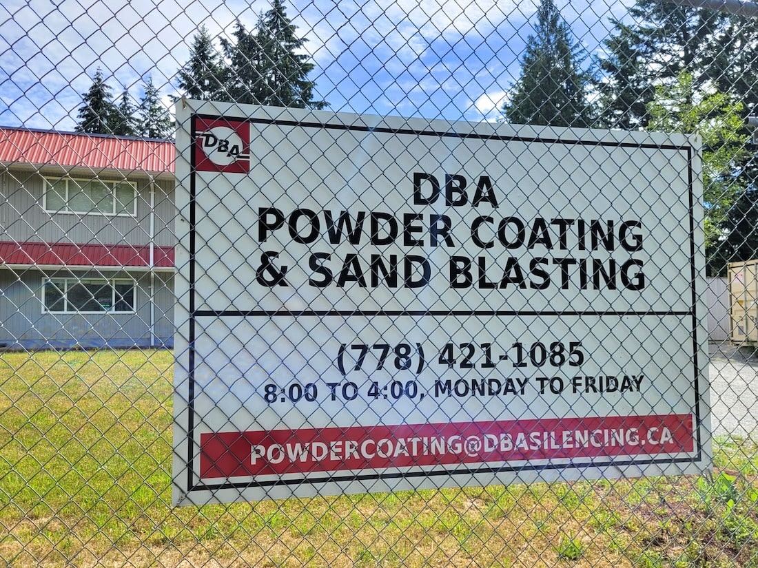 DBA Silencing building with powder coating and sand blasting services sign and contact information