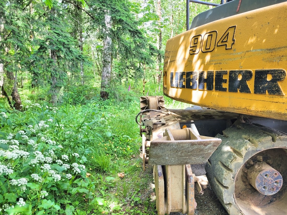 Mining truck Liebherr 904 in the green grass for exhaust systems FAQ