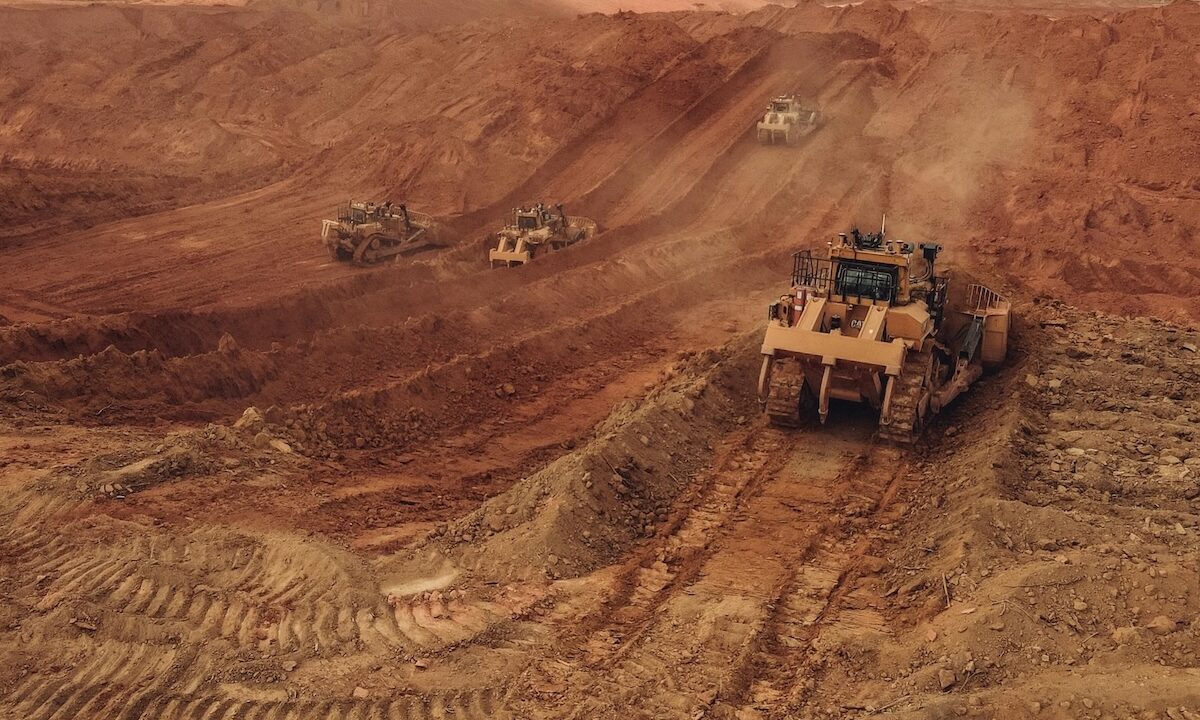 Caterpillar Bulldozers Clearing Dusty Red Soil At A Rugged Mining Site, Requiring Reliable Heavy-Duty Parts For Operation