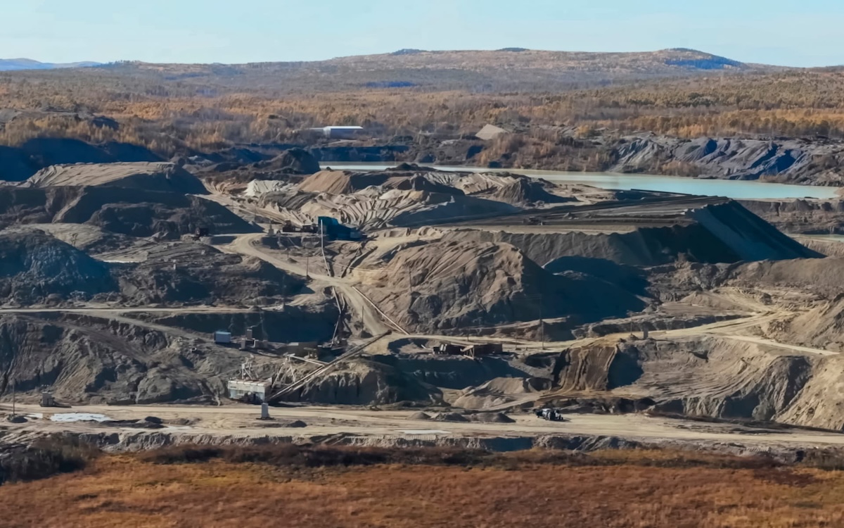 Expansive View Of A Remote Mining Site With Haul Roads And Excavation Zones In Harsh Terrain