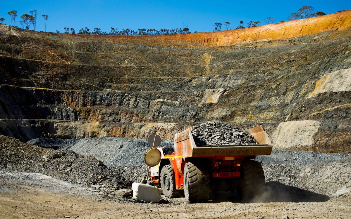 Mining Truck Loaded With Rock Ascending An Open-Pit Mine, Equipped With High-Performance Heavy Duty Parts For Extreme Hauling