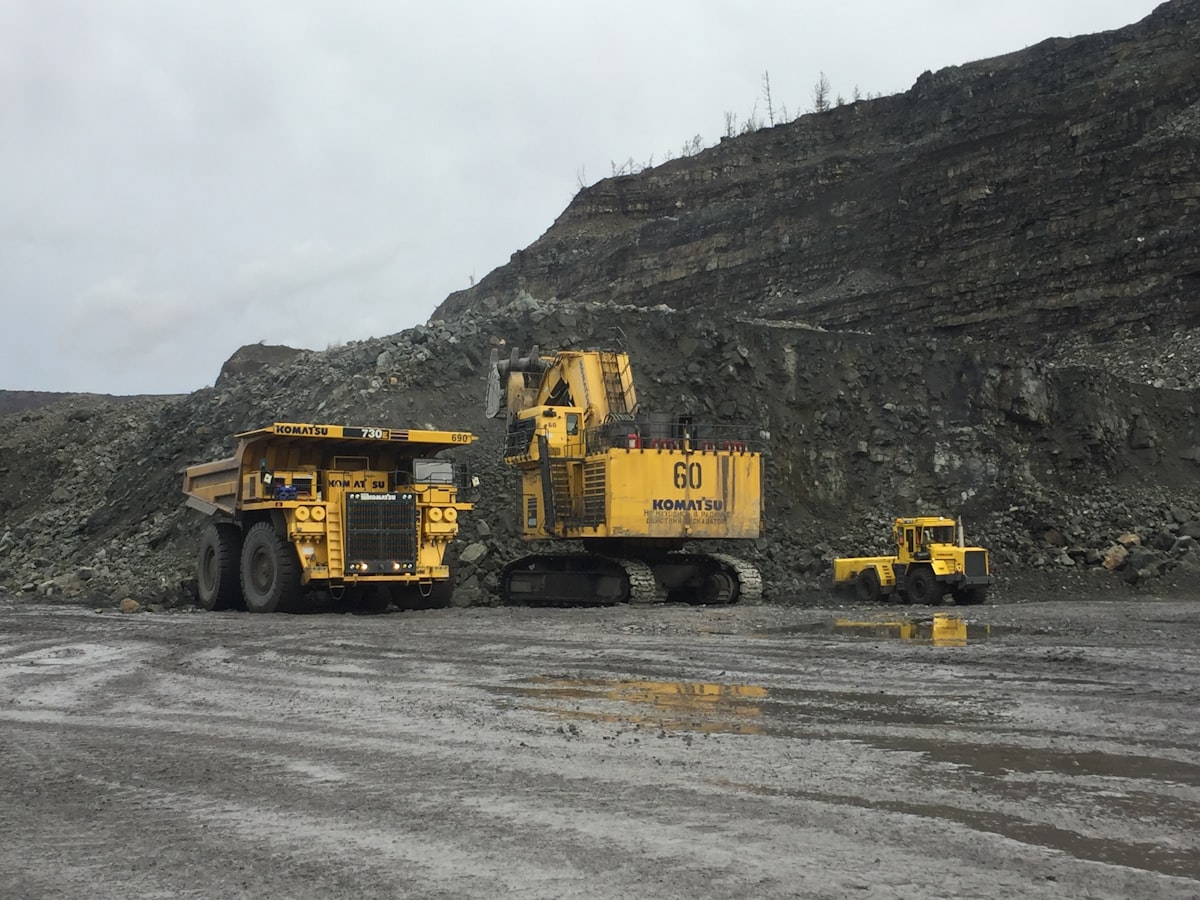 Yellow Mining Haul Truck On Road Near Mountain — Dust And Heat Causes Of Mining Truck Overheating