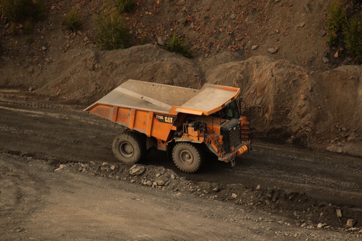 Orange Haul Truck On Mine Site Road — Mining Truck Overheating Solutions By Dba Silencing