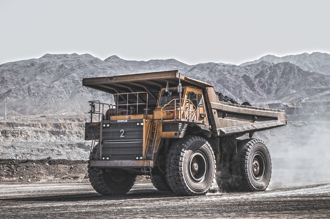 Large Yellow Haul Truck On Open Pit Mine Site Road — Mining Truck Exhaust Parts By Dba Silencing